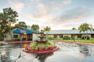 the front of the Aviara Healthcare facility trees and bushes and flowers