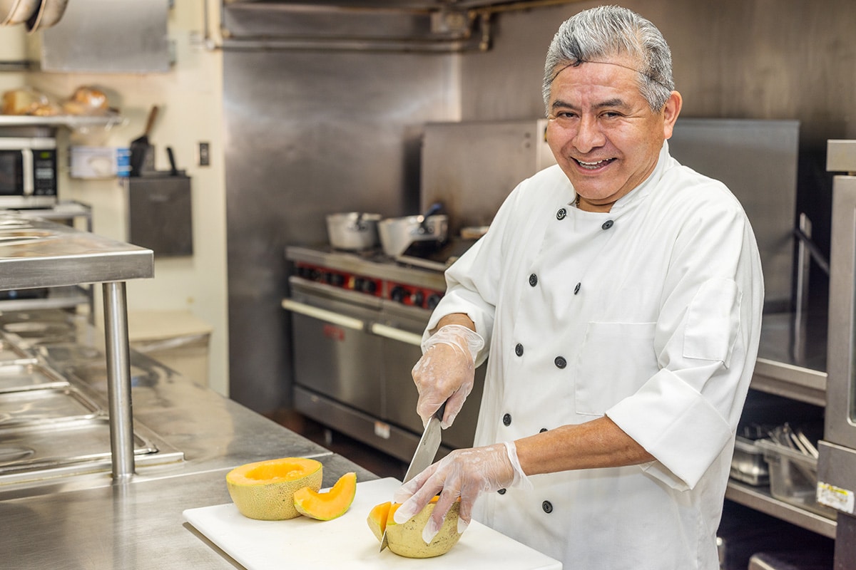a chef in the kitchen of the Aviara Healthcare