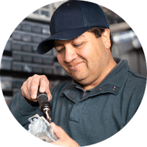 maintenance man smiling and working with a screwdriver