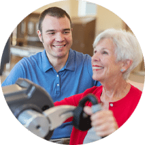smiling rehab nurse assisting an elderly woman with an arm exercise